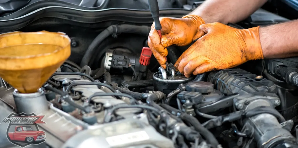 Mechanic performing engine maintenance at BZ Kustomz